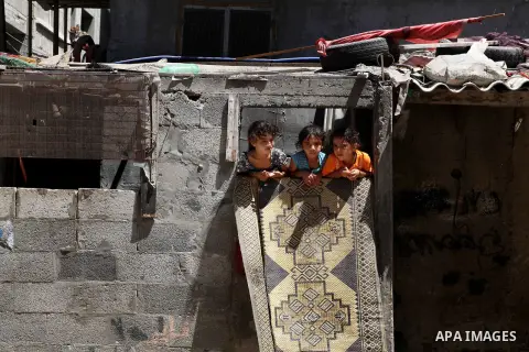 Palestinian children See from the window of their home at Al-Shati refugee camp in Gaza City on August 28, 2012. Life in the poor and crowded Gaza Strip is going to get harsher still unless action is taken now, according...
