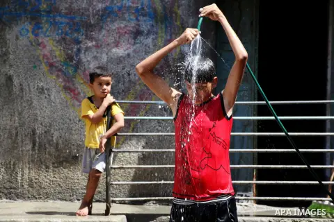 A Palestinian boy enjoys himself with water during hot weather at Al-Shati refugee camp in Gaza City on August 28, 2012. Life in the poor and crowded Gaza Strip is going to get harsher still unless action is taken now, a...