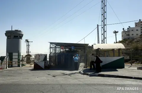Palestinians walk past the military checkpoint of Ras Khamees on Aug 28,2012. The second military checkpoint of Ras Khamees between Jerusalem and Shu'fat refugee camp, will be close according to Israeli Ministry of Defen...