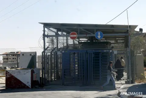 A Palestinian youth walks past the military checkpoint of Ras Khamees on Aug 28,2012. The second military checkpoint of Ras Khamees between Jerusalem and Shu'fat refugee camp, will be close according to Israeli Ministry...
