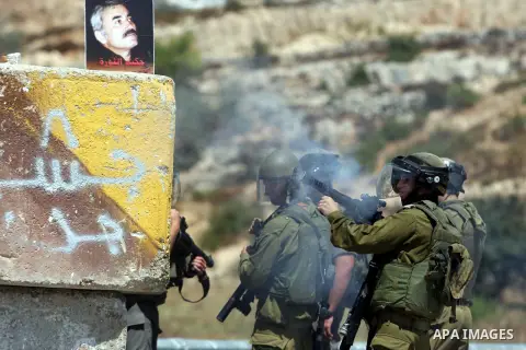 Israeli soldiers fire tear gas at Palestinian protesters outside the Ofer military prison, near the West Bank city of Ramallah, on August 28, 2012, during a demonstration in solidarity with Palestinian prisoners being he...
