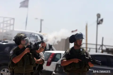 Israeli soldiers fire tear gas at Palestinian protesters outside the Ofer military prison, near the West Bank city of Ramallah, on August 28, 2012, during a demonstration in solidarity with Palestinian prisoners being he...