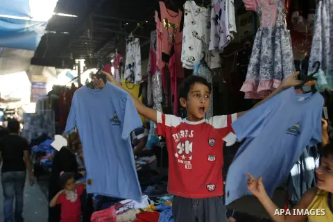 A Palestinian boy sells school uniforms at Rafah's market in the southern Gaza strip on Aug 28, 2012. Next Sunday the First day for the new school year according to Palestinian Ministry of Education in the Gaza strip and...