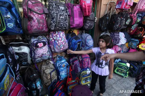 A Palestinian girl looks at school bags displayed at a market in Gaza city on Aug 28, 2012. Next Sunday the First day for the new school year according to Palestinian Ministry of Education in the Gaza strip and the West...