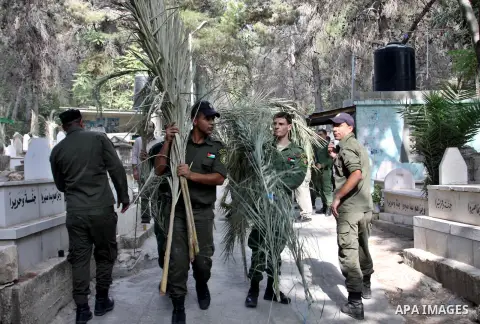 Palestinian security members volunteer clean the cemeteries during the campaign "Cleanliness " in the West Bank city OF Nablus, on Aug. 29, 2012. Photo by Nedal Eshtayah