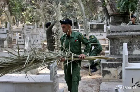 Palestinian security members volunteer clean the cemeteries during the campaign "Cleanliness " in the West Bank city OF Nablus, on Aug. 29, 2012. Photo by Nedal Eshtayah