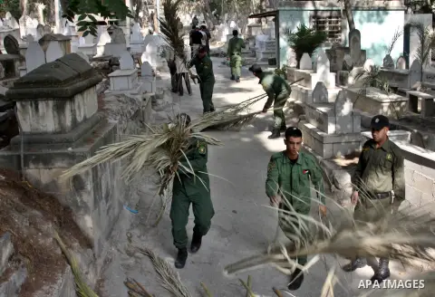Palestinian security members volunteer clean the cemeteries during the campaign "Cleanliness " in the West Bank city OF Nablus, on Aug. 29, 2012. Photo by Nedal Eshtayah