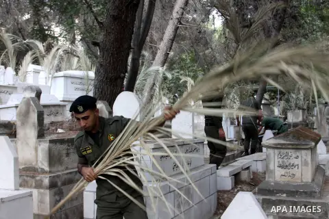 Palestinian security members volunteer clean the cemeteries during the campaign "Cleanliness " in the West Bank city OF Nablus, on Aug. 29, 2012. Photo by Nedal Eshtayah