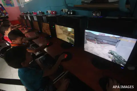 Palestinian children play computer games in a video game club, four days before the beginning of new school year in Gaza city, on Aug 29, 2012. Next Sunday the First day for the new school year according to Palestinian M...