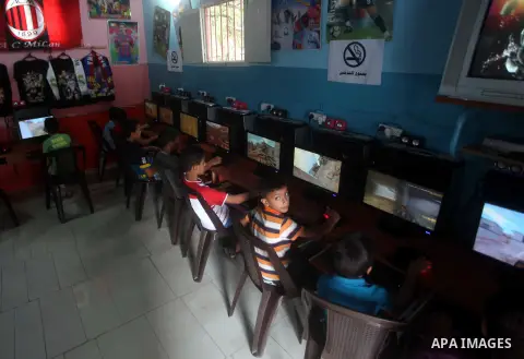 Palestinian children play computer games in a video game club, four days before the beginning of new school year in Gaza city, on Aug 29, 2012. Next Sunday the First day for the new school year according to Palestinian M...