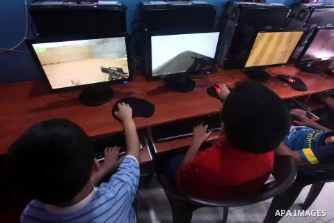 Palestinian children play computer games in a video game club, four days before the beginning of new school year in Gaza city, on Aug 29, 2012. Next Sunday the First day for the new school year according to Palestinian M...