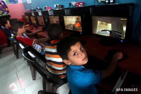 Palestinian children play computer games in a video game club, four days before the beginning of new school year in Gaza city, on Aug 29, 2012. Next Sunday the First day for the new school year according to Palestinian M...