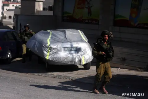 Israeli soldiers fire tear gas at Palestinian youths during an incursion to Om al-Sharayet neighborhood, in the West Bank city of Ramallah, Wednesday, Aug 29, 2012. Israeli soldiers raided a store in Om al-Sharayet and l...