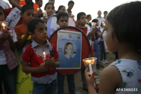 Palestinian children hold candles during a protest in Rafah in the southern Gaza Strip, against an Israeli court's ruling, August 29, 2012. The Israeli court on Tuesday cleared Israel's military of any blame for the deat...