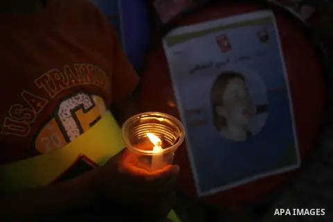 Palestinian children hold candles during a protest in Rafah in the southern Gaza Strip, against an Israeli court's ruling, August 29, 2012. The Israeli court on Tuesday cleared Israel's military of any blame for the deat...