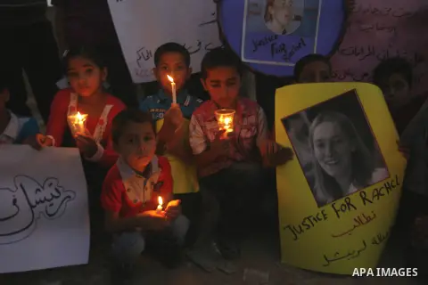 Palestinian children hold candles during a protest in Rafah in the southern Gaza Strip, against an Israeli court's ruling, August 29, 2012. The Israeli court on Tuesday cleared Israel's military of any blame for the deat...
