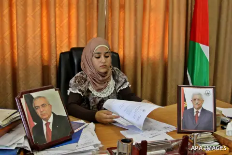 Palestinian mayor teenager Bashaer Othman, 15, sits behind her desk at the town hall of the West Bank village of Allar, north of Tulkarem, on August 30, 2012. Othman became mayor as part of a program from Allar's municip...