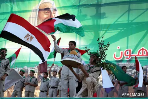 Palestinian boy scouts hold Islamic countries flags during a festival entitled "Jerusalem in our eyes"organized by Hamas movement, marking the 43rd anniversary of burning down al-Aqsa mosque in Gaza city on 30 Aug 2012....