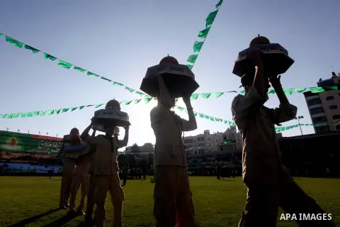 Palestinian boy scouts carry statues of the Dome of the Rock mosque during a festival entitled "Jerusalem in our eyes" organized by Hamas movement, marking the 43rd anniversary of burning down al-Aqsa mosque in Gaza city...