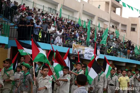 Palestinian boy scouts hold Islamic countries flags during a festival entitled "Jerusalem in our eyes"organized by Hamas movement, marking the 43rd anniversary of burning down al-Aqsa mosque in Gaza city on 30 Aug 2012....