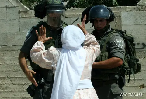 Palestinian woman attacks Israeli soldiers during clashes against the expropriation of Palestinian land by Israel in the village of Kafr Qaddum, near the West Bank city of Nablus on August 31, 2012. Photo by Nedal Eshtay...