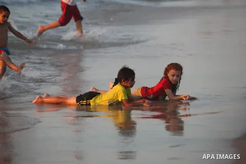 Palestinian children play at the beach during the last Friday holiday before the beginning of new school year in Gaza city, Aug 31, 2012. Next Sunday is the First day for the new school year according to Palestinian Mini...