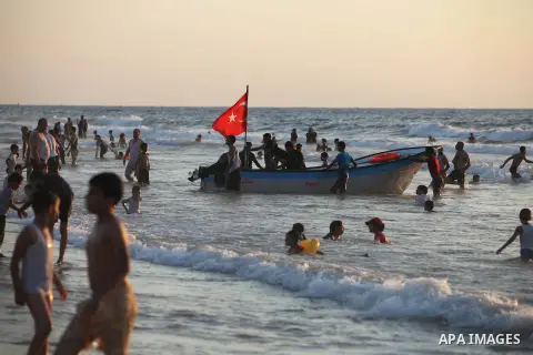 Palestinians ride a boat off the coast of Gaza during the last Friday holiday before the beginning of new school year in Gaza city, Aug 31, 2012. Next Sunday is the First day for the new school year according to Palestin...