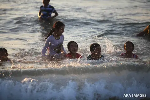 Palestinian children play at the beach during the last Friday holiday before the beginning of new school year in Gaza city, Aug 31, 2012. Next Sunday is the First day for the new school year according to Palestinian Mini...