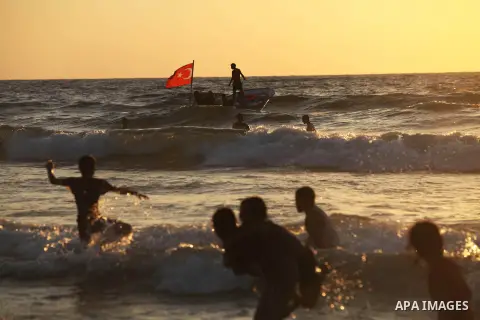 Palestinians ride a boat off the coast of Gaza during the last Friday holiday before the beginning of new school year in Gaza city, Aug 31, 2012. Next Sunday is the First day for the new school year according to Palestin...