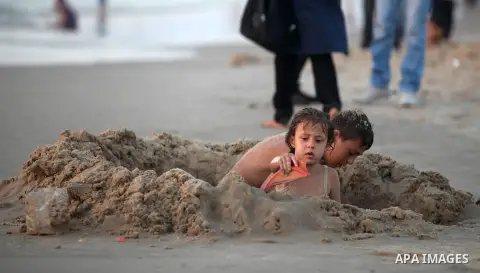 Palestinian children play at the beach during the last Friday holiday before the beginning of new school year in Gaza city, Aug 31, 2012. Next Sunday is the First day for the new school year according to Palestinian Mini...