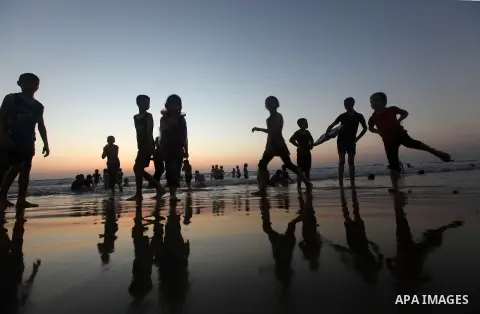 Palestinian children play at the beach during the last Friday holiday before the beginning of new school year in Gaza city, Aug 31, 2012. Next Sunday is the First day for the new school year according to Palestinian Mini...