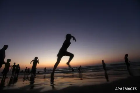 Palestinian children play at the beach during the last Friday holiday before the beginning of new school year in Gaza city, Aug 31, 2012. Next Sunday is the First day for the new school year according to Palestinian Mini...