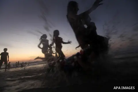 Palestinian children play at the beach during the last Friday holiday before the beginning of new school year in Gaza city, Aug 31, 2012. Next Sunday is the First day for the new school year according to Palestinian Mini...