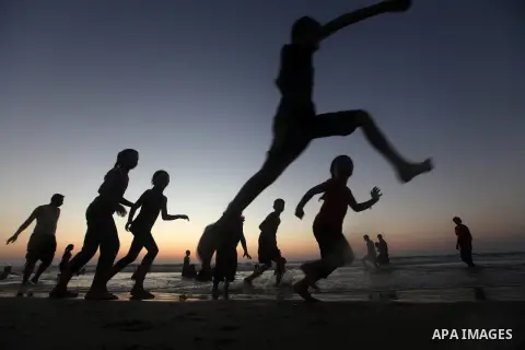 Palestinian children play at the beach during the last Friday holiday before the beginning of new school year in Gaza city, Aug 31, 2012. Next Sunday is the First day for the new school year according to Palestinian Mini...