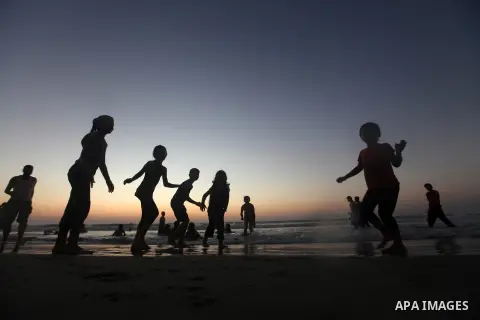 Palestinian children play at the beach during the last Friday holiday before the beginning of new school year in Gaza city, Aug 31, 2012. Next Sunday is the First day for the new school year according to Palestinian Mini...