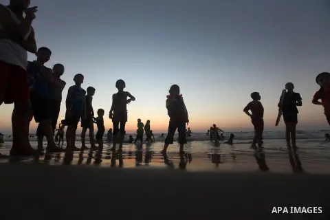 Palestinian children play at the beach during the last Friday holiday before the beginning of new school year in Gaza city, Aug 31, 2012. Next Sunday is the First day for the new school year according to Palestinian Mini...