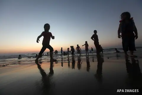 Palestinian children play at the beach during the last Friday holiday before the beginning of new school year in Gaza city, Aug 31, 2012. Next Sunday is the First day for the new school year according to Palestinian Mini...