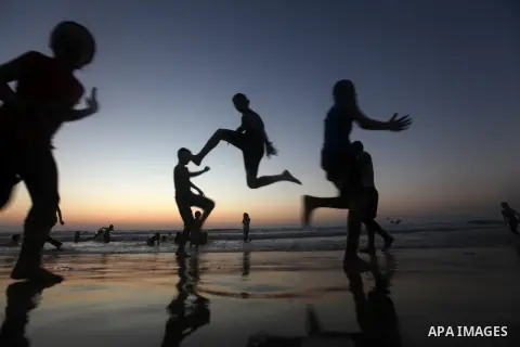 Palestinian children play at the beach during the last Friday holiday before the beginning of new school year in Gaza city, Aug 31, 2012. Next Sunday is the First day for the new school year according to Palestinian Mini...