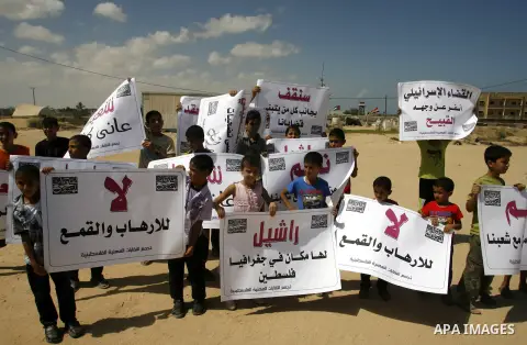 Palestinian children attend a protest calling for justice for Rachel Corrie in Rafah, Gaza Strip, Sep. 01, 2012. An Israeli court ruled that Israel did not intentionally kill pro-Palestinian activist Rachel Corrie, run o...
