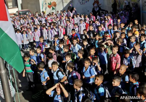 Palestinian students return back to their schools in the morning of the first day of the new year study in the West Bnak city of Nablus on Sep. 02, 2012. The academic year began in the Gaza Strip and West Bank on Sept. 0...