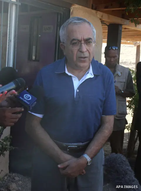 Palestinian Prime Minister Salam Fayyad speaks to press after his visit to "al-Khan al-Ahmar" school , on the first day of the new school year, in Abu Hindi valley in the bedouin, in occupied West Bank near Jericho, on S...
