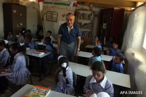 Palestinian Prime Minister Salam Fayyad visits the school "al-Khan al-Ahmar", on the first day of the new school year, in Abu Hindi valley in the bedouin, in occupied West Bank near Jericho, on September 2, 2012. Photo b...