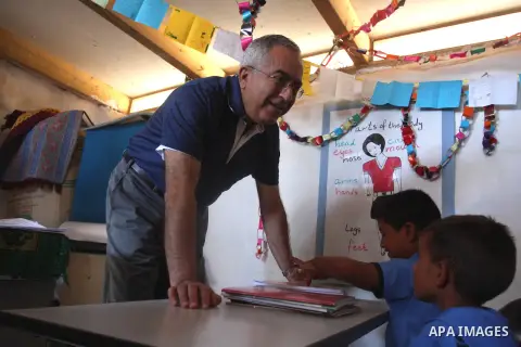 Palestinian Prime Minister Salam Fayyad visits the school "al-Khan al-Ahmar", on the first day of the new school year, in Abu Hindi valley in the bedouin, in occupied West Bank near Jericho, on September 2, 2012. Photo b...
