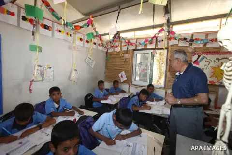 Palestinian Prime Minister Salam Fayyad speaks to press after his visit to "al-Khan al-Ahmar" school , on the first day of the new school year, in Abu Hindi valley in the bedouin, in occupied West Bank near Jericho, on S...