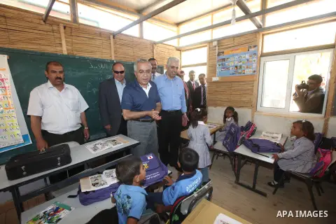 Palestinian Prime Minister Salam Fayyad speaks to press after his visit to "al-Khan al-Ahmar" school , on the first day of the new school year, in Abu Hindi valley in the bedouin, in occupied West Bank near Jericho, on S...