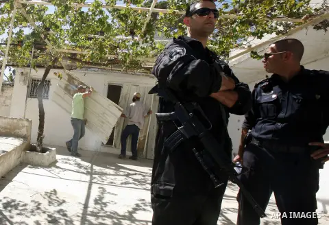 Israeli police stand guards while Israeli Jewish settlers work at a Palestinian house after Israeli police evict his owner in Ras al-Amoud neighborhood, south of al-Aqsa Mosque in Jerusalem's Old City, on 02 Septemper 20...