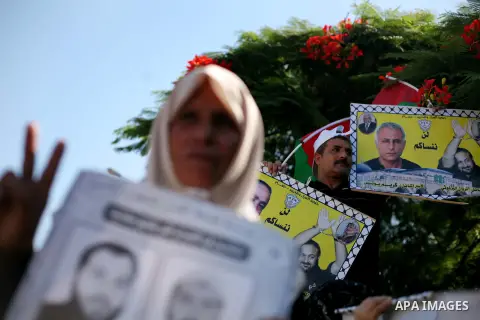 Palestinians hold a placard depicting jailed relatives during a protest in Gaza City calling for the release of Palestinian prisoners from Israeli jails September 3, 2012. Photo by Ashraf Amra
