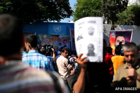 Palestinians hold a placard depicting jailed relatives during a protest in Gaza City calling for the release of Palestinian prisoners from Israeli jails September 3, 2012. Photo by Ashraf Amra