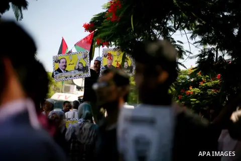 Palestinians hold a placard depicting jailed relatives during a protest in Gaza City calling for the release of Palestinian prisoners from Israeli jails September 3, 2012. Photo by Ashraf Amra