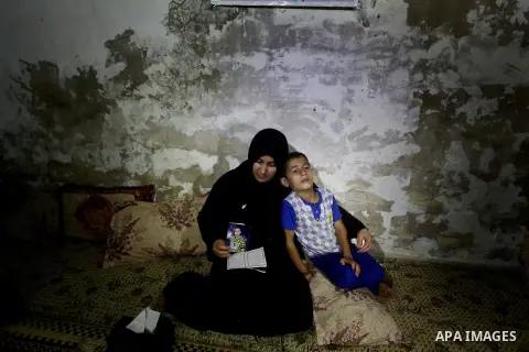 Palestinian Nadia Abu Nada holds a picture of her son Ihab Abu Nada at her home in the Shati refugee camp in Gaza City, Monday, Sept. 3, 2012. The death of a young Gaza man who set himself on fire because he could not fi...